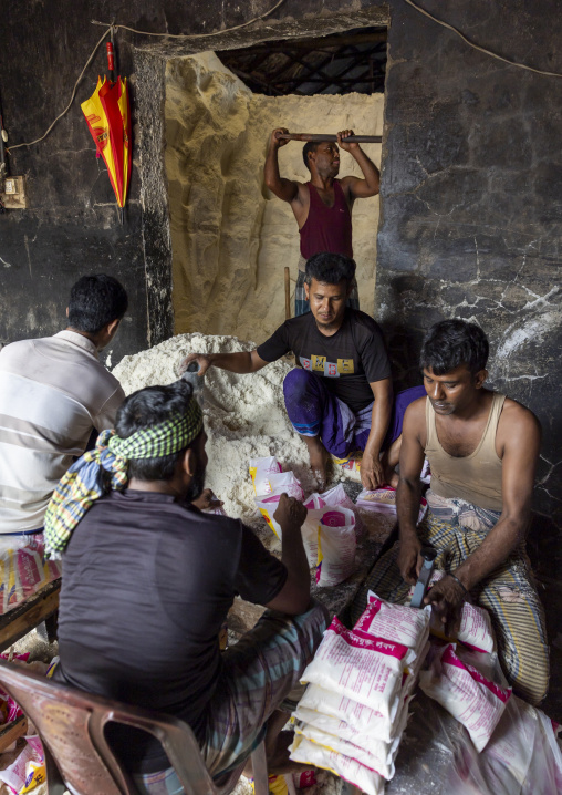 Bangladeshi men packing salt in plastic bags, Chittagong Division, Chittagong, Bangladesh