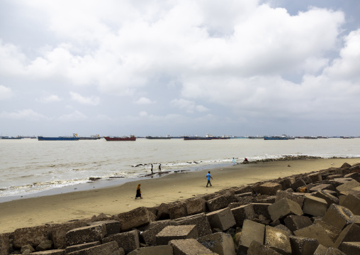 People walking on the beach with tanker ships on the horizon, Chittagong Division, Chittagong, Bangladesh