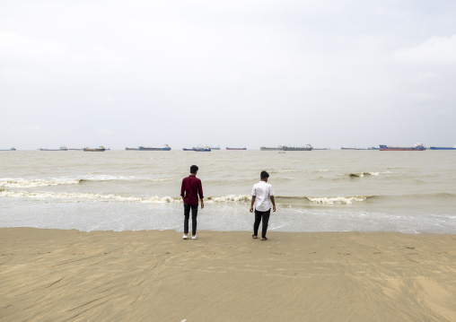 Men on the beach looking at tanker ships, Chittagong Division, Chittagong, Bangladesh