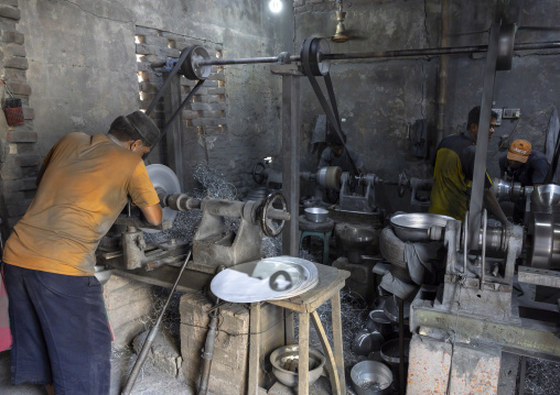 Bangladeshi worker making metal bowls, Dhaka Division, Dhaka, Bangladesh