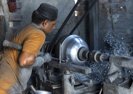 Bangladeshi worker making metal bowls, Dhaka Division, Dhaka, Bangladesh