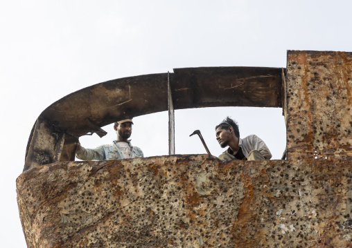 Workers at Dhaka Shipyard removing rust, Dhaka Division, Keraniganj, Bangladesh