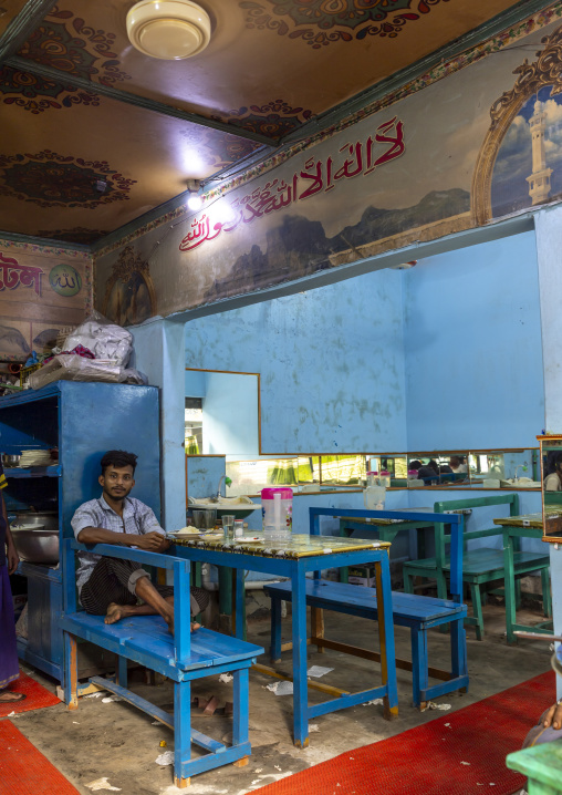Bangladeshi man sit in an empty muslim restaurant, Dhaka Division, Keraniganj, Bangladesh