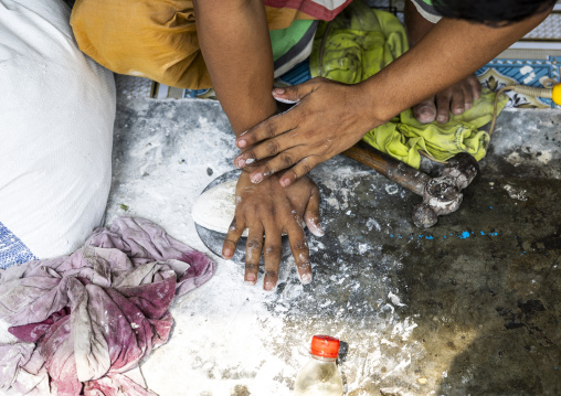 Metal worker using old lost wax casting method to create jewels, Dhaka Division, Dhamrai, Bangladesh