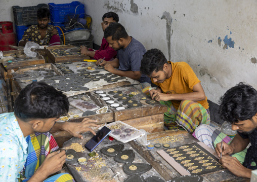 Metal worker using old lost wax casting method to create jewels, Dhaka Division, Dhamrai, Bangladesh