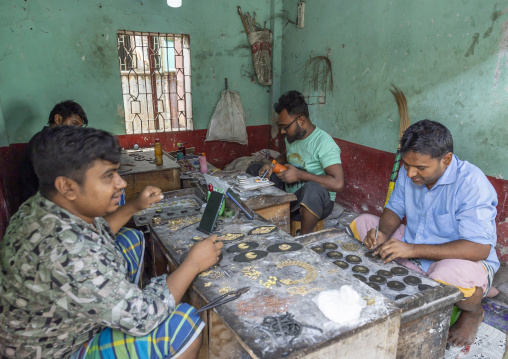 Metal worker using old lost wax casting method to create jewels, Dhaka Division, Dhamrai, Bangladesh
