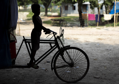 Silhouette of a boy riding a rickshaw, Dhaka Division, Shivalaya, Bangladesh