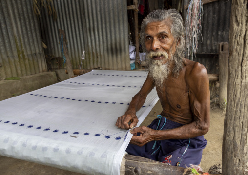 Bangladeshi eledery man repairing a khanta, Dhaka Division, Delduar, Bangladesh