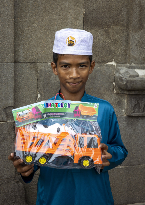 Portrait of a muslim boy hiolding a truck toy in Kusumba Mosque, Rajshahi Division, Kusumba, Bangladesh