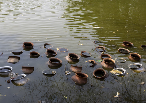 Pots thrown in a pond after a wedding, Rajshahi Division, Tanore, Bangladesh