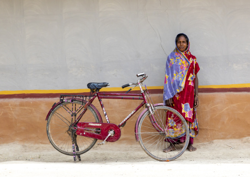 Chritsian woman from Santal ethnic group near a bicycle, Rajshahi Division, Tanore, Bangladesh
