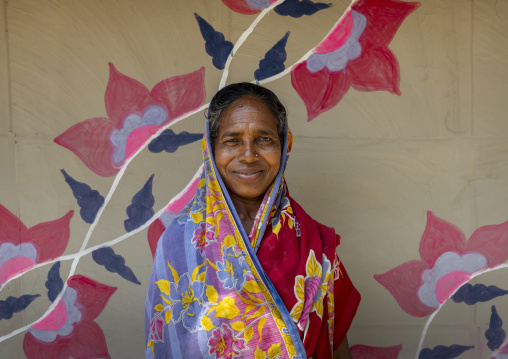 Christian woman from Santal ethnic group in front of a wall painting, Rajshahi Division, Tanore, Bangladesh