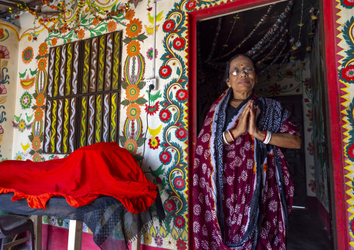 Hindu woman in front of a traditional wall painting in a house, Rajshahi Division, Tikoil, Bangladesh