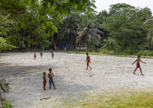 Bangladeshi boys playing football in the countryside, Dhaka Division, Muksudpur, Bangladesh