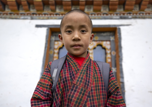 Bhutanese novice monk back from school in Nyenzer Lhakhang, Thedtsho Gewog, Wangdue Phodrang, Bhutan