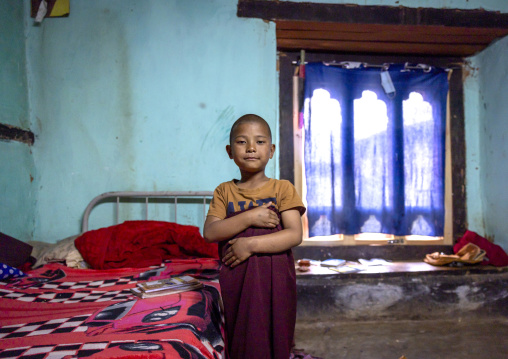 Bhutanese novice monk in Nyenzer Lhakhang dormitory, Thedtsho Gewog, Wangdue Phodrang, Bhutan
