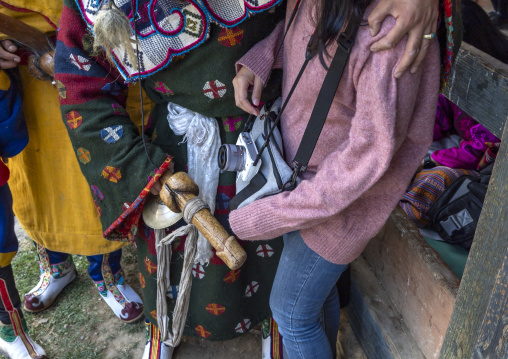Atsara showing a wooden phallus to a tourist at the Ura Yakchoe festival, Bumthang, Ura, Bhutan