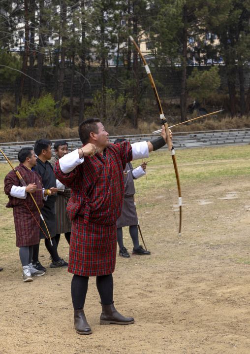 Bhutanese man aims arrow in archery competition, Chang Gewog, Thimphu, Bhutan