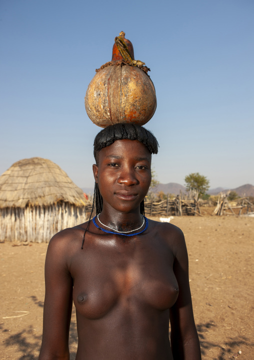 Mucawana girl carrying a jar on her water, Cunene province, Oncocua, Angola