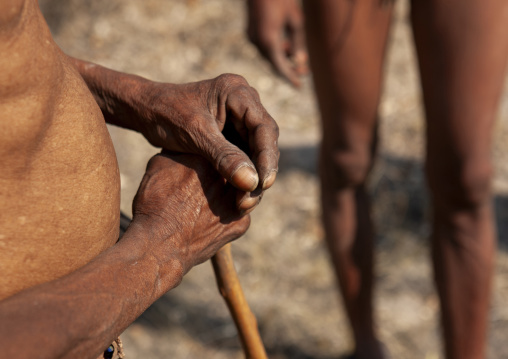 San hands holding a walking stick, Otjozondjupa, Tsumkwe, Namibia