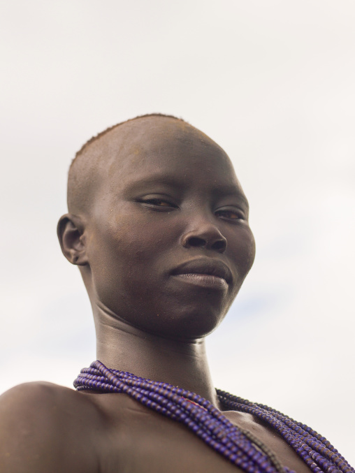 Karo tribe woman with beaded necklaces and shaved head, Omo valley, Korcho, Ethiopia