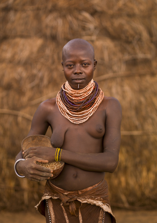 Portrait of a Karo tribe woman holding a calabash, Korcho, Omo valley, Ethiopia