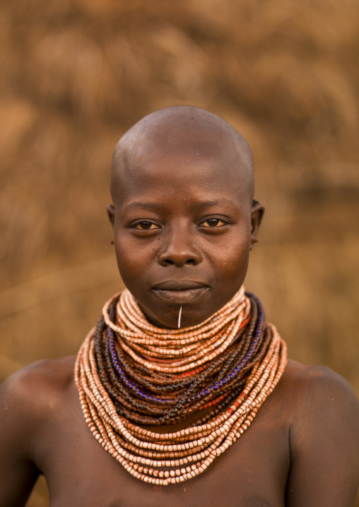 Portrait of a Karo tribe woman holding a calabash, Korcho, Omo valley, Ethiopia