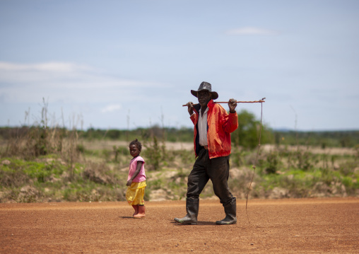 Man and young girl walking on the road, Huila Province, Lubango, Angola