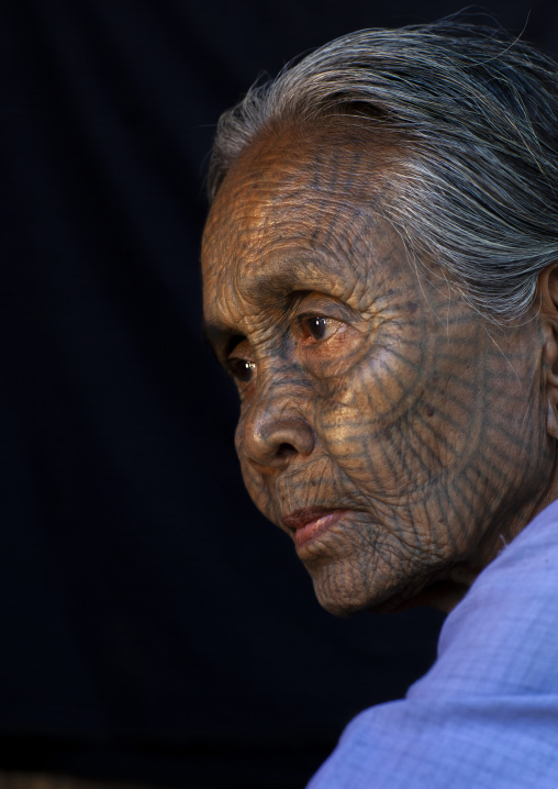 Tribal chin woman with spiderweb tattoo on the face, Rakhine state, Mrauk U, Myanmar