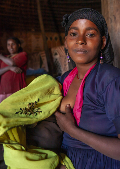 Portrait of a young ethiopian mother breastfeeding, Kembata, Alaba, Ethiopia