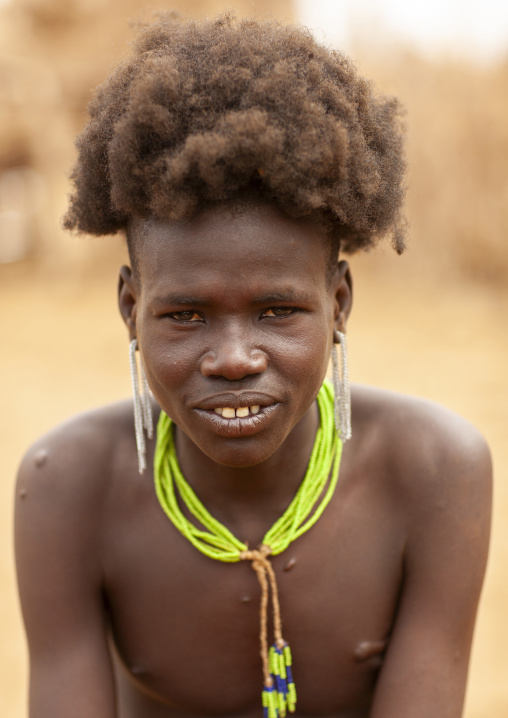 Hairy Dassanech teenage boy portrait, Omo valley, Omorate, Ethiopia