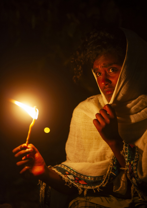 Orthodox pilgrims with a candle at timkat festival, Amhara Region, Lalibela, Ethiopia