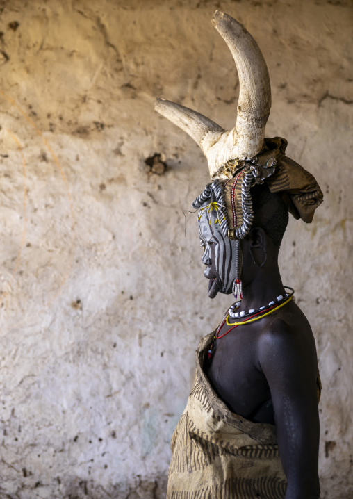 Mursi tribe woman with cow horns on her head, Omo valley, Hail Wuha, Ethiopia