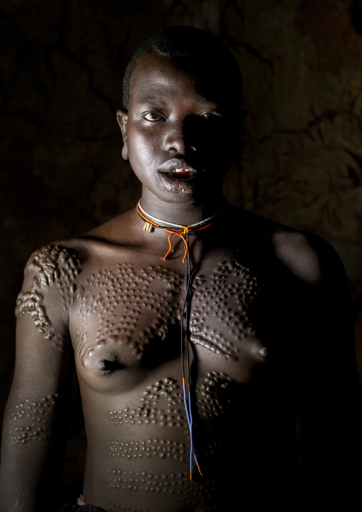 Suri woman with decorative scarifications, Kibbish village, Omo valley, Ethiopia