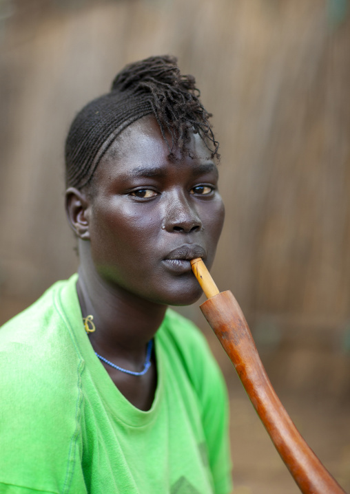 Anuak tribe woman smoking pipe, Dima, Gambela province, Ethiopia