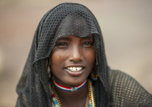 Portrait of a smiling Karrayyu young woman, Oromia, Metahara, Ethiopia