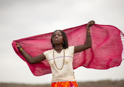 Portrait of a Karrayyu teenage girl with pink shawl, Oromia, Metahara, Ethiopia