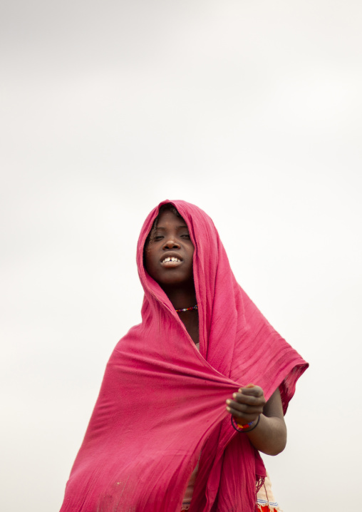 Portrait of a Karrayyu teenage girl with pink shawl, Oromia, Metahara, Ethiopia