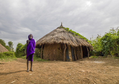 Surma boy in front of a hut, Kibish, Omo valley, Ethiopia