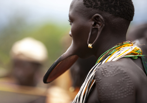 Suri woman with lip plate, Enlarged earlobe and scarifications, Kibish, Omo valley, Ethiopia
