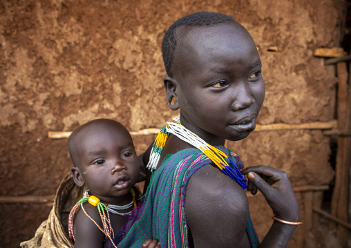 Suri tribe woman holding her baby, Kibish, Omo valley, Ethiopia