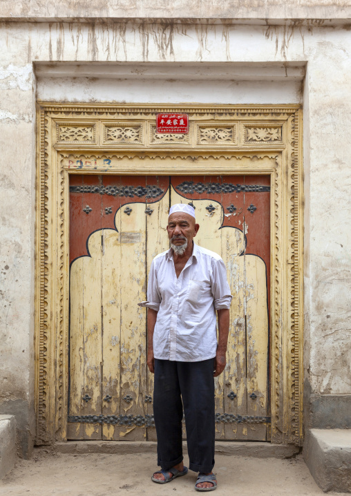 Uyghur man in front of a traditional door, Keriya, Xinjiang uyghur autonomous region, China