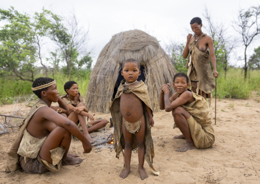 Bushman tribe people around a fire in a village, Otjozondjupa, Tsumkwe, Namibia