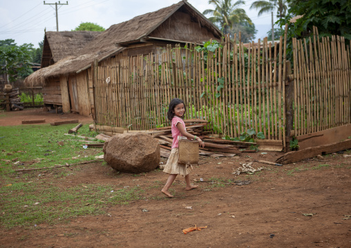 Alak girl with a bamboo basket in a village, Champassak province, Boloven, Laos