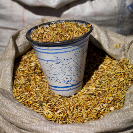 Seeds for sale in the mercato with an enamel cup with ethiopian lion, Central Region, Asmara, Eritrea