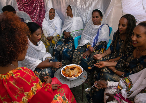 Eritrean women eating during a wedding celebration, Central region, Asmara, Eritrea