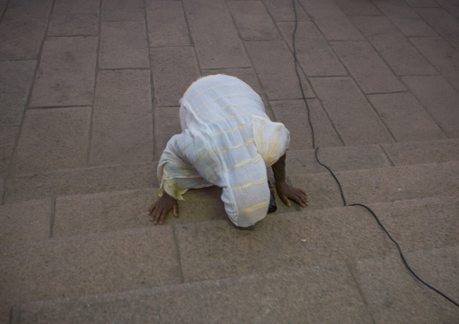 Eritrean woman praying in front of a church, Central Region, Asmara, Eritrea