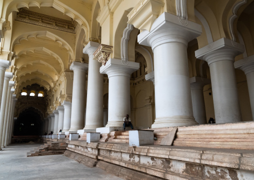 People sit in the Pillared hall of Thirumalai Nayakar Palace, Tamil Nadu, Madurai, India