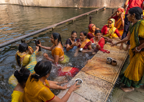 Indian pilgrims having a bath in Galtaji temple aka monkey temple, Rajasthan, Jaipur, India