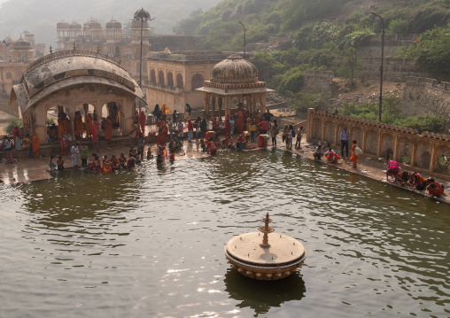 Indian pilgrims having a bath in Galtaji temple aka monkey temple, Rajasthan, Jaipur, India